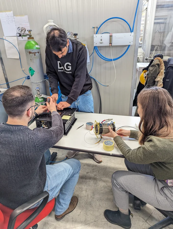 Students assembling detector hardware in the laboratory