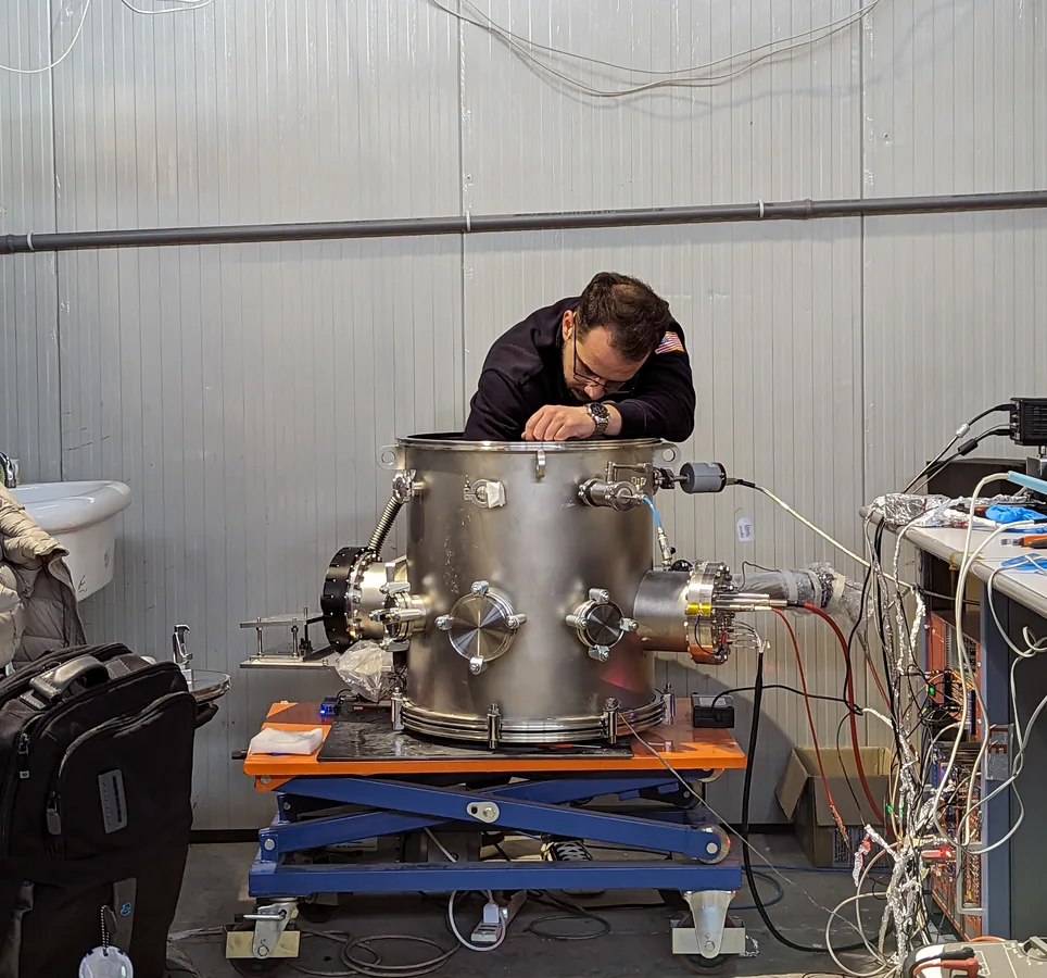 Researcher working on an optical TPC detector during commissioning